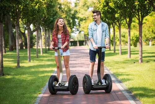Young couple on a Segway ride in a park